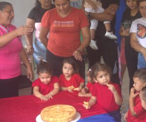 Children and community celebrating "Mi Pequeña Lucecita" 21st anniversary